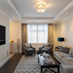living area with TV, 2 chairs, sofa and small table, Hyde Park Apartments, Mayfair, London W1