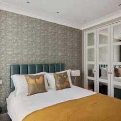 bedroom with double bed, side table with lamp, built-in wardrobes with mirrors, Hyde Park Apartments, Mayfair, London W1