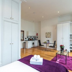 studio with bed, kitchen, dining table and wardrobe, Longridge Apartments, Kensington, London SW5
