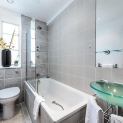bathroom with toilet, bathtub, sink and mirror, Old Brompton Apartments, Kensington, London SW5