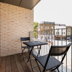 balcony with table and chairs, view to shops, Portobello Road Apartments, Notting Hill, London W10