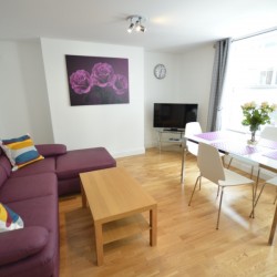 living room with double sofa bed and dining table, Wardour Serviced Apartments, Soho, London
