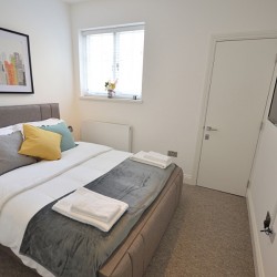 bedroom with TV and king size bed, living area with double sofa bed and dining table, Anne’s Apartments, Soho, London W1