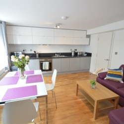 living area with sofa bed, dining table and kitchen, Wardour Serviced Apartments, Soho, London