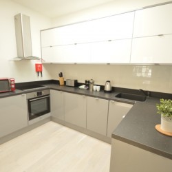 fully equipped kitchen for self catering, living area with double sofa bed and dining table, Anne’s Apartments, Soho, London W1