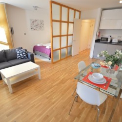 studio apartment with double bed, sofa, dining table and kitchen, Greek Street Studios, Soho, London