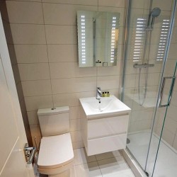 shower room, living area with double sofa bed and dining table, Anne’s Apartments, Soho, London W1