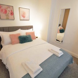 double bedroom, living area with double sofa bed and dining table, Anne’s Apartments, Soho, London W1