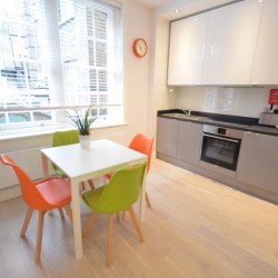kitchen and dining table, living area with double sofa bed and dining table, Anne’s Apartments, Soho, London W1
