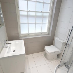 shower room, living area with double sofa bed and dining table, Anne’s Apartments, Soho, London W1