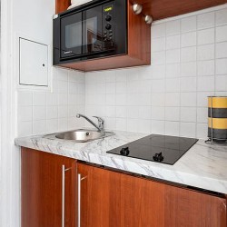 kitchenette with cooking hob, sink and microwave, Old Brompton Apartments, Kensington, London SW5