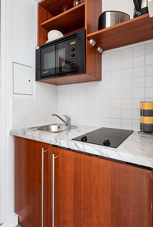 kitchenette with cooking hob, sink and microwave, Old Brompton Apartments, Kensington, London SW5