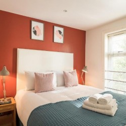 bedroom with double bed, towels and side tables, Goodge Street Apartments, Fitzrovia, London W1