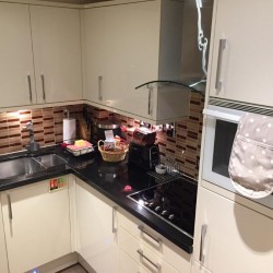 kitchen with cooking hob, microwave and welcome pack, Beaufort Apartments, Knightsbridge, London SW3