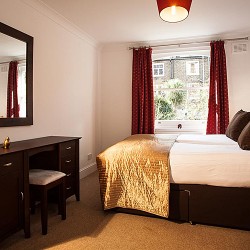 bedroom with work desk and twin beds, Hammersmith Apartments, Hammersmith, London W6