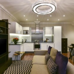 living room with sofa, book shelves, kitchen and dining area, Stanhope Luxury Homes, Kensington, London SW7