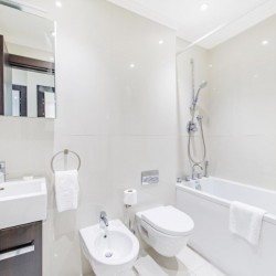 bathroom with shower over bathtub, kensington, london sink