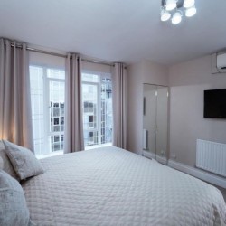 bedroom with king size bed and tv, Edgware Road Apartments, Marylebone, London W1