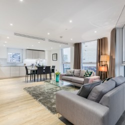 open plan living room with seating, dining table and kitchen, Riverside Apartments, Vauxhall, London