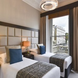 bedroom with twin beds, side lamps and balcony, Stanhope Luxury Homes, Kensington, London SW7
