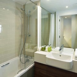 bathroom with bathtub and shower, sink and towels, Holborn Apart Hotel, Holborn, London WC1