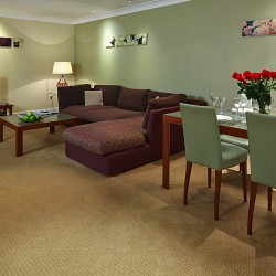 brown sofa, dining area with flowers, Knightsbridge Apartments, Knightsbridge, London SW3