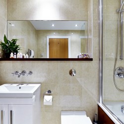 bathroom with sink, large mirror and bath tub with shower, South Kensington Luxury, Kensington, London SW7