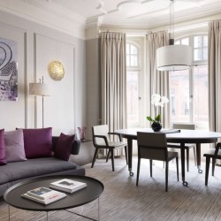 living room with dining table and large windows, Piccadilly Apartments, Mayfair, London
