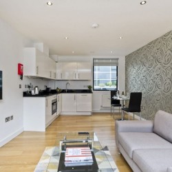 living room with sofa and modern kitchen for self-catering, Court Apartments, Holborn, London EC4