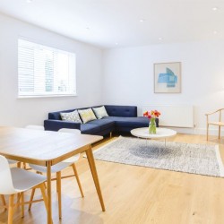 large living room with dining area, sofa, wood floors with rug, small table and side table with TV, Fulham Apartments, Fulham, London SW6