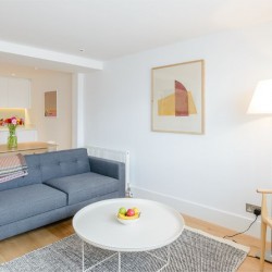open plan living area with kitchen, table, sofa, coffee table, chair and lamp, Fulham Apartments, Fulham, London SW6