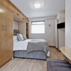 open murphy bed, tv and shelves, Oxford Street Apartments, Marylebone, London W1