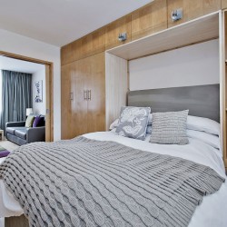 murphy bed and view to living room with sofa, Oxford Street Apartments, Marylebone, London W1