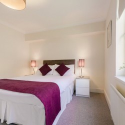 bedroom and side tables, green plant, Cascades Apartments, Wimbledon, London SW19
