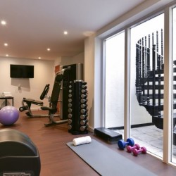 gym with equipment and stairs from garden, Stanhope Luxury Homes, Kensington, London SW7