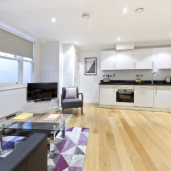 studio living room with seating, smart tv and kitchen, Court Apartments, Holborn, London EC4