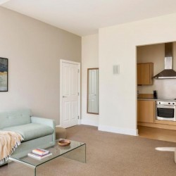 living area with sofa and kitchen, Cathedral Apartments, Cardiff CF11, Wales