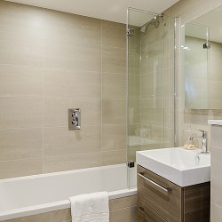 bathroom with shower over bathtub