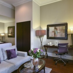 living area with sofa, small table, work desk and double bed, Queen's Apart Hotel, Kensington, London SW7