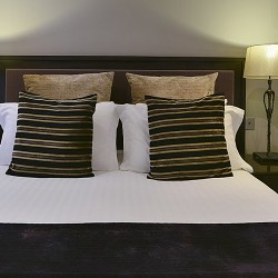 double bed and side tables with lamps, Queen's Apart Hotel, Kensington, London SW7