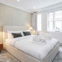 double bedroom with bathrobes and towels, The Mews Apartments, Mayfair, London