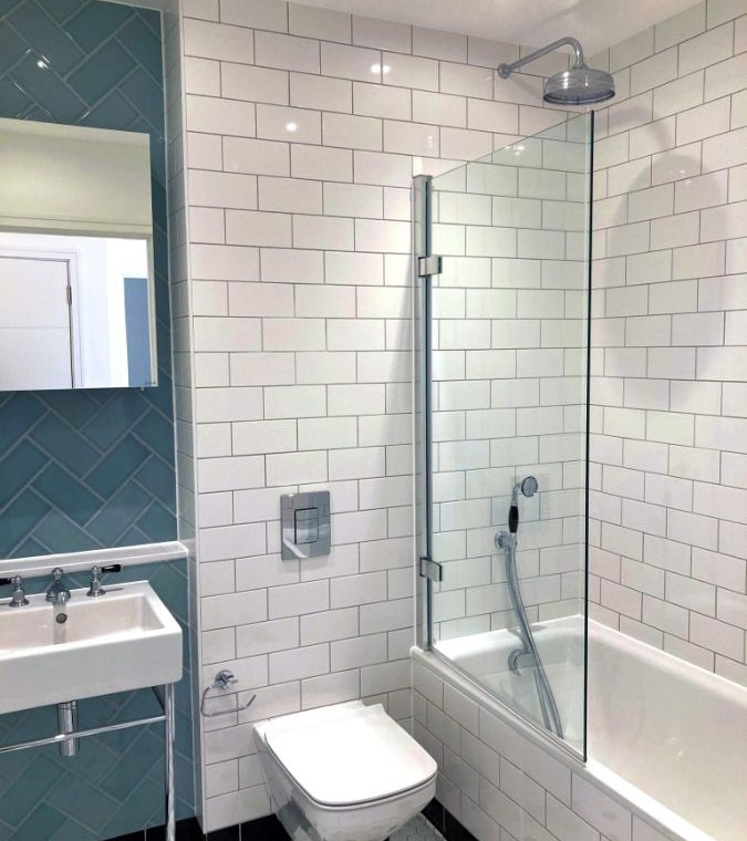 tiled bathroom with shower over bath tub
