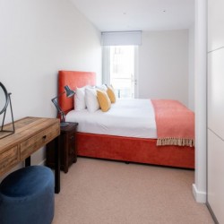 bedroom with wood table and wardrobes, Victoria Apartments, Victoria, London SW1
