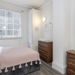 double bedroom with wardrobes and drawers, Buckingham Apartments, Victoria, London SW1