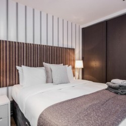 double bed, side tables with lamps and fitted wardrobe, Garrick Apartments, Covent Garden, London WC2