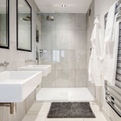 bathroom with sink, mirror, towel rails and bathrobes, Garrick Apartments, Covent Garden, London WC2