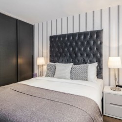 double bed, side tables with lamps and fitted wardrobes, Garrick Apartments, Covent Garden, London WC2