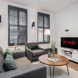living room with sofa, chair, coffee table and tv with netflix, Garrick Apartments, Covent Garden, London WC2