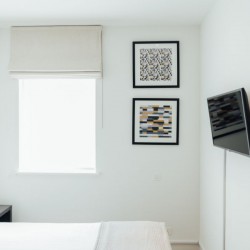 bedroom with wall-mounted tv, Wigmore Street Apartments, Marylebone, London W1