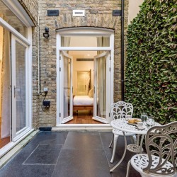 terrace with dining table and view to bedroom, Hyde Park Apartments 1, Kensington, London SW7